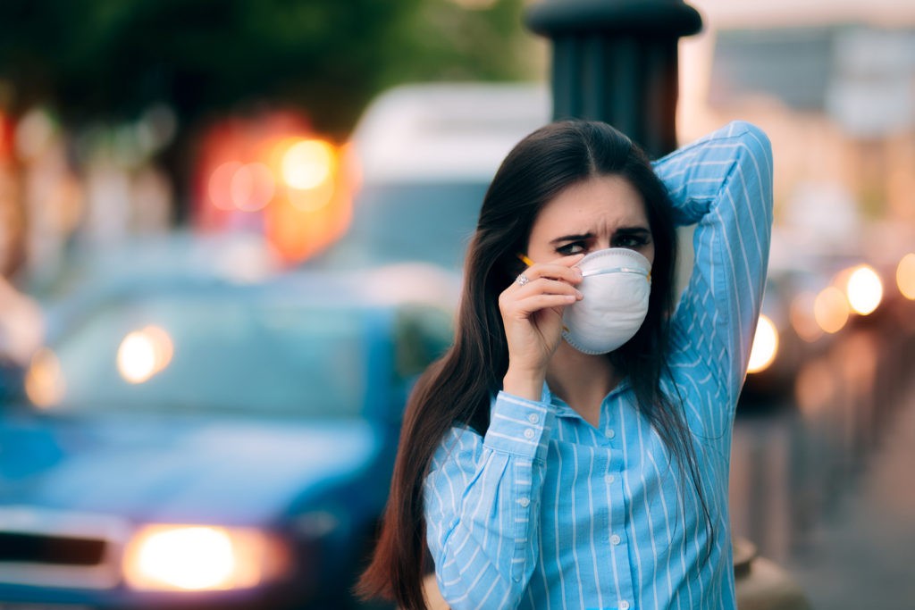 Woman With Respiratory Mask Out in Polluted City